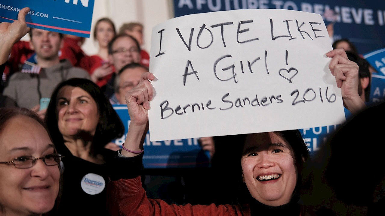 Una partidaria de Bernie Sanders celebra la victoria con un cartel en el que se puede leer: