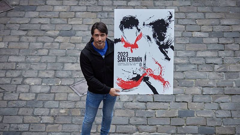 Raúl López, el artista que ha creado el cartel de San Fermín 2023, posa con su obra