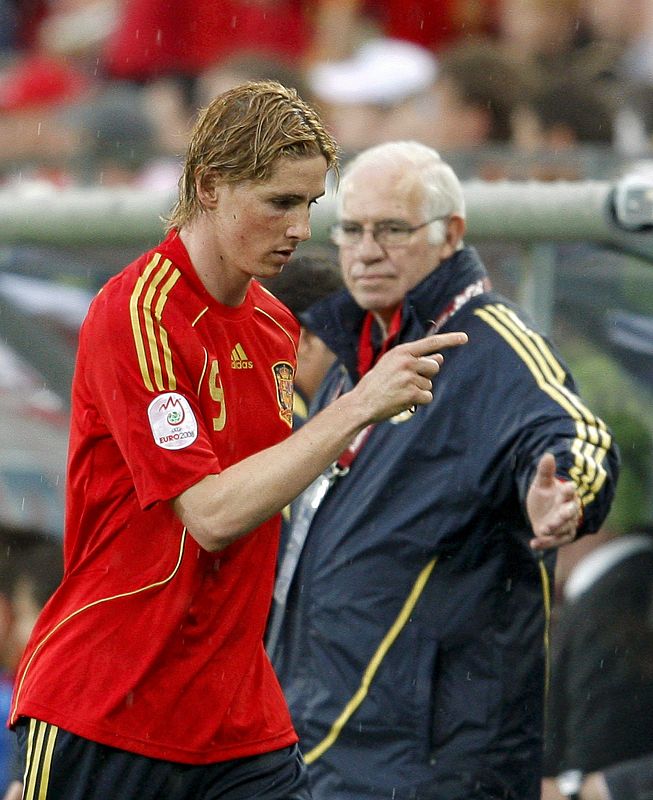 El delantero español Fernando Torres pasa por delante de Aragonés, tras ser sustituído ante Rusia.