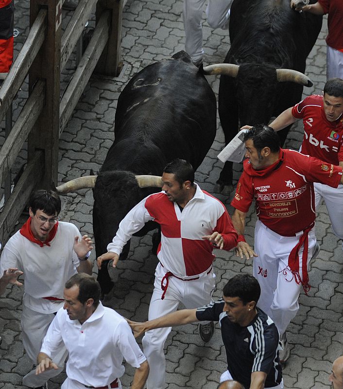 Runners are chased by a pack of Jandilla fighting bulls near the entrance to the bullring in Pamplona