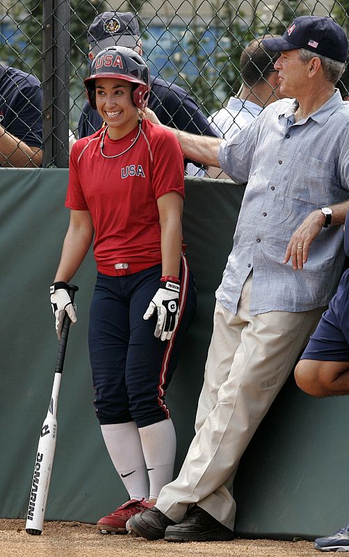 U.S. President George W. Bush watches batting practice next to U.S. Women's softball team player Andrea Duran in Beijing