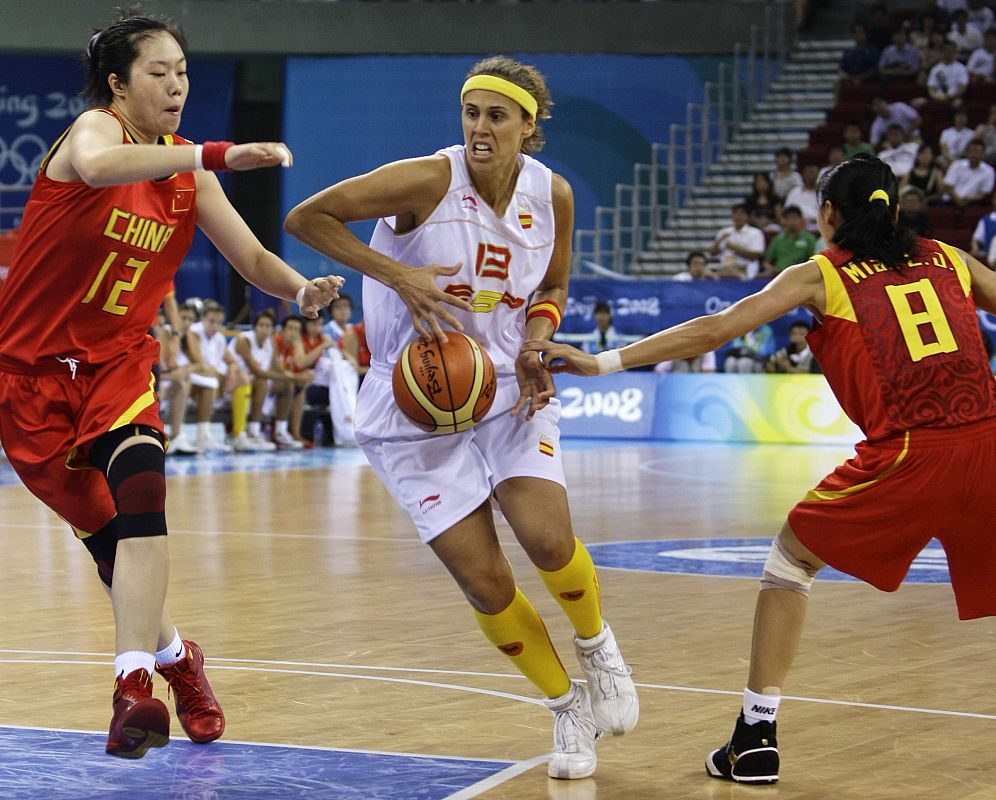 Spain's Valdemoro goes to basket against China's Chen and Miao during women's basketball game at Beijing 2008 Olympic Games