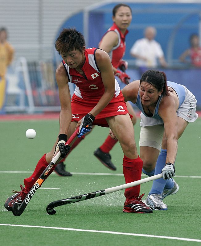 Miura of Japan is challenged by Claxton of New Zealand during their preliminary hockey match at the Beijing 2008 Olympic Games