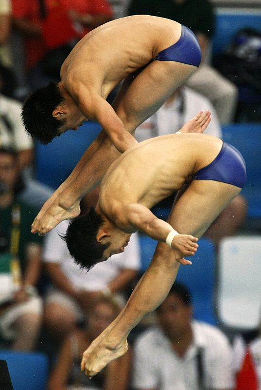 Lin and Huo of China compete in the men's 10m platform synchronized diving final at the Beijing 2008 Olympic Games