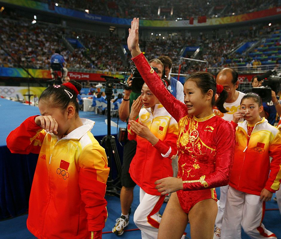 Cheng Fei of China celebrates with teammates after winning the women's team artistic gymnastics gold medal at the Beijing 2008 Olympic Games