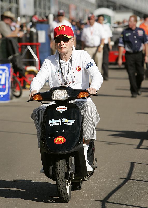 Actor Paul Newman drives his scooter back to his garage after the morning practice round during the Grand Prix of Edmonton, in Edmonton.