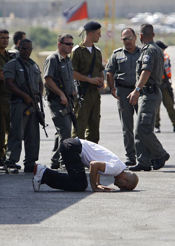 A Palestinian prisoner touches the ground upon his release at the Beitunya checkpoint outside Ramallah