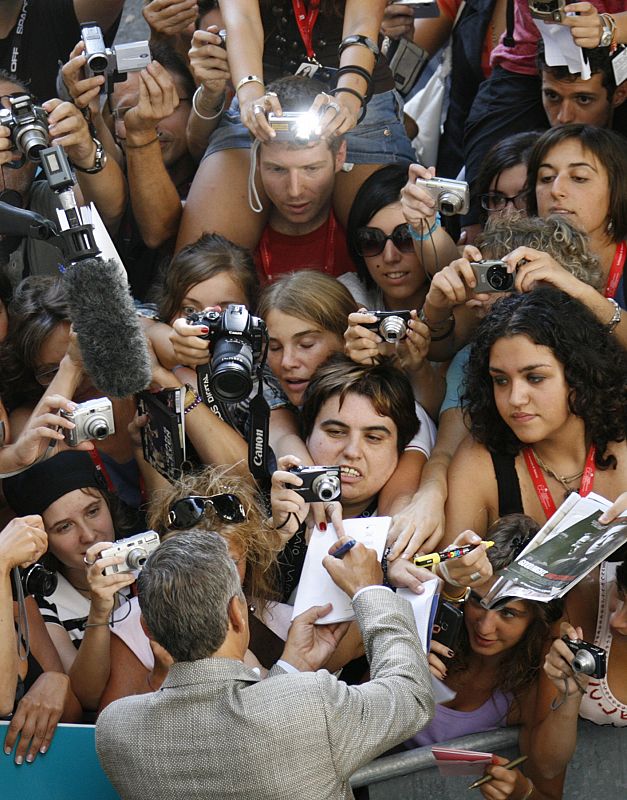 U.S. actor Clooney signs autograph at the Cinema Palace in Venice