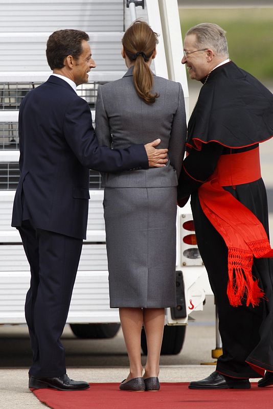 France's President Nicolas Sarkozy  his wife Carla Bruni-Sarkozy and Cardinal Andre Vingt-Trois wait for the arrival of Pope Benedict XVI at Orly Airport, near Paris