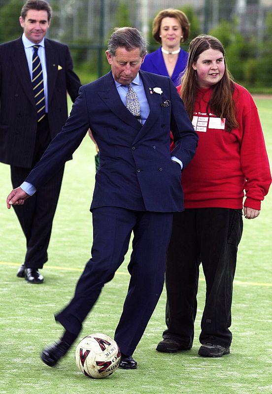 PRINCE CHARLES KICKS A BALL DURING A VISIT TO HIBERNIAN SOCCER TRAINING GROUND.