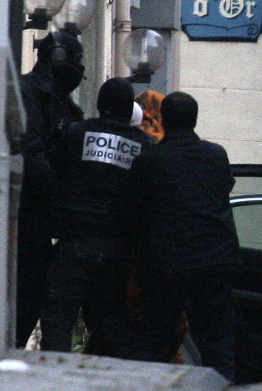 Suspected Basque separatist rebel group ETA military chief  Garikoitz Aspiazu Rubina, known as "Txeroki" or "Cherokee", is escorted by hooded police during a transfer in Cauterets