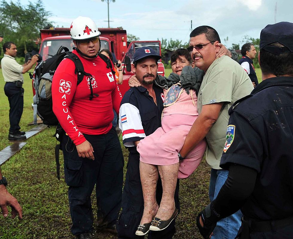 Una mujer es socorrida por miembros de la Cruz Roja.