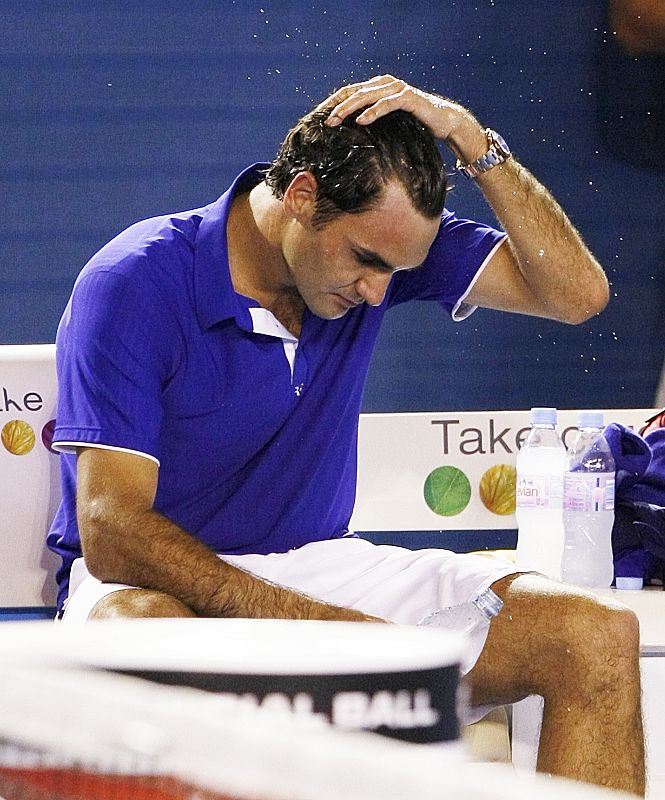 Switzerland's Federer pours water over himself after losing his men's singles final match against Spain's Nadal at the Australian Open