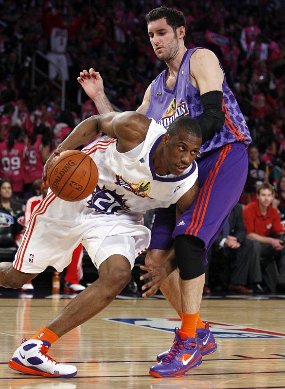 Sophomore's Thaddeus Young from the Philadelphia Sixers drives past Rookie's Rudy Fernandez from the Portland Trailblazers during the Rookie Challenge at the NBA All-Star basketball weekend in Phoenix