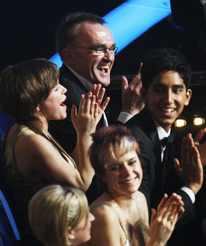 Boyle, director of "Slumdog Millionaire" and actor Patel cheer for winners of best original song during the 81st Academy Awards in Hollywood