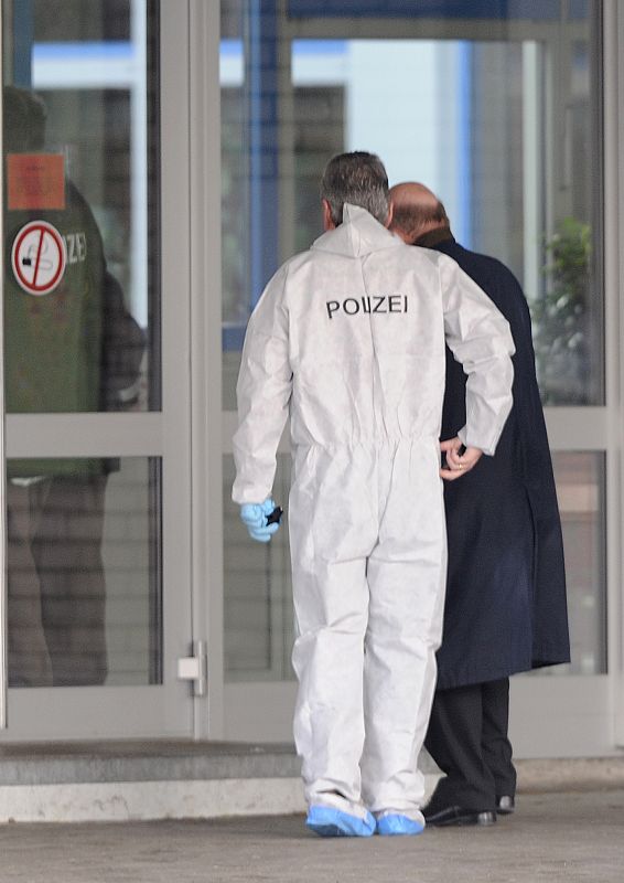 Police forensic experts enter a school where a shooting incident took place in Winnenden