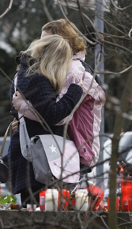 Students hug each other near the Albertville-Realschule school where a shooting incident took place in Winnenden