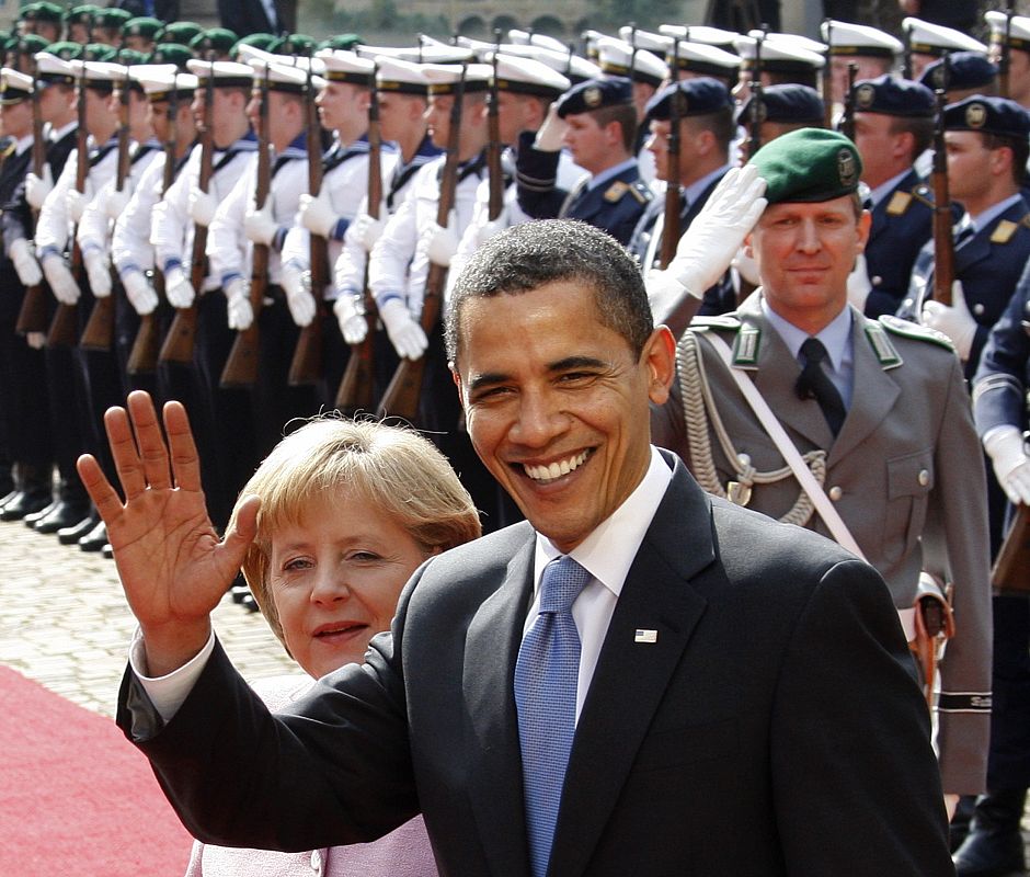 U.S. President Obama waves as he and German Chancellor Merkel inspect the guard of honour during a welcoming ceremony in Baden-Baden