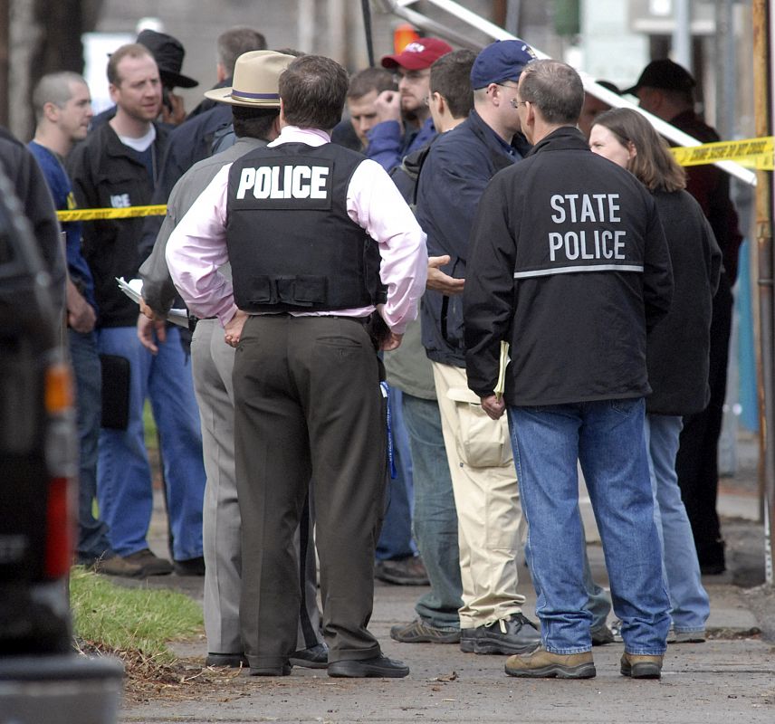 Police investigate a shooting scene outside the American Civic Center on Front Street in Binghampton