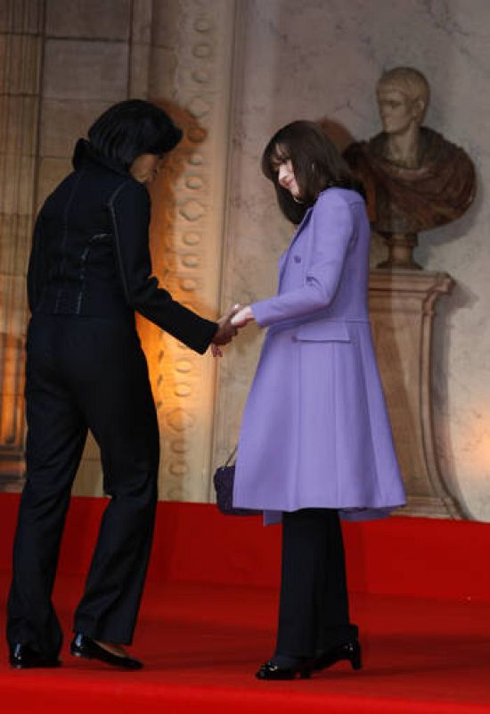 France's first lady Carla Bruni-Sarkozy and U.S. first lady Michelle Obama hold hands as they arrive for the visit of the Strasbourg's Cathedral 