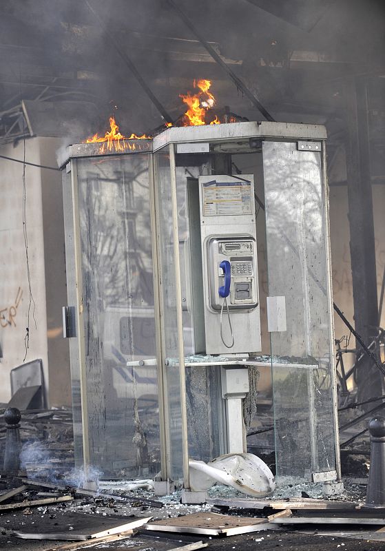 Burnt out telephone boxes are pictured  outside a burning supermarket near the French-German border crossing between Kehl and Strasbourg