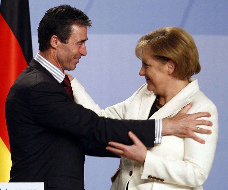 Denmark's Prime Minister Fogh Rasmussen is congratulated by German Chancellor Merkel during the NATO summit closing news conference in Strasbourg