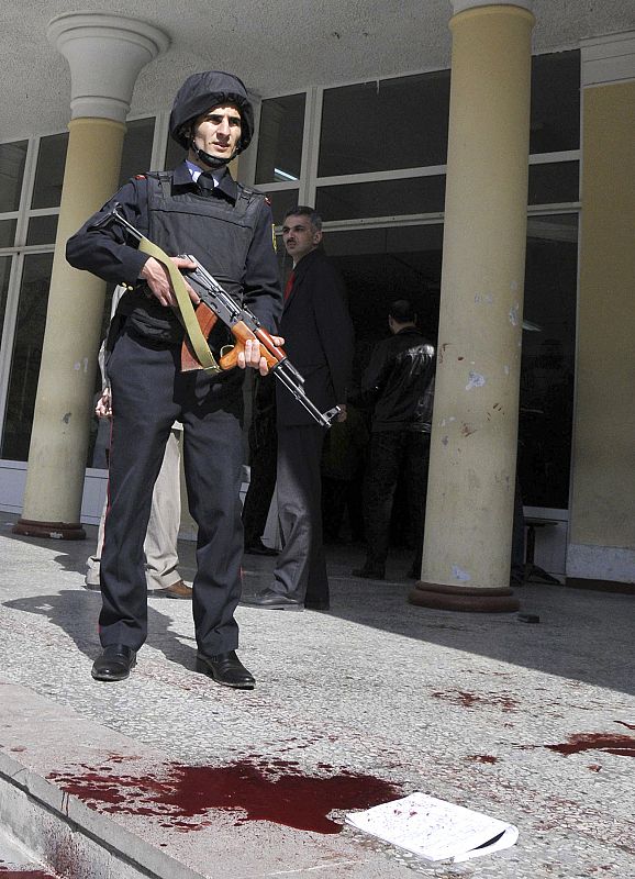 An Interior Ministry serviceman stands guard at the entrance into a university after a shooting in Baku