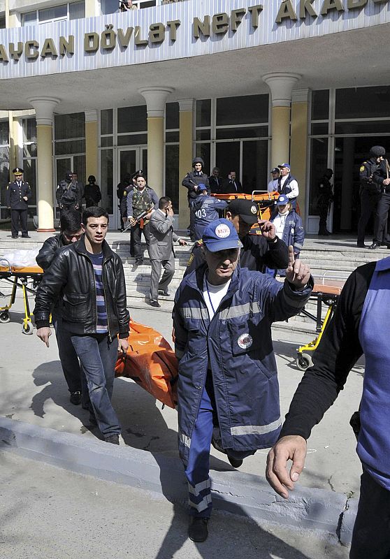 The body of a victim of a shooting at a university is carried to a van in Baku