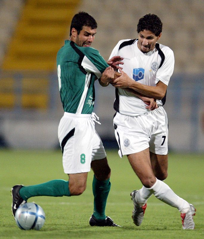 Rizk of al-Sadd club fights for the ball during Qatar's Emir Cup.