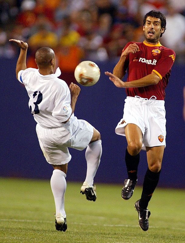 REAL MADRID'S ROBERTO CARLOS GOES FOR BALL AGAINST A.S. ROMA'S JOSEP