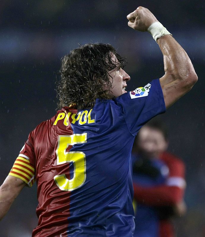 Barcelona's Puyol celebrates Eto'o's goal against Real Madrid during Spanish First Division soccer match in Barcelona