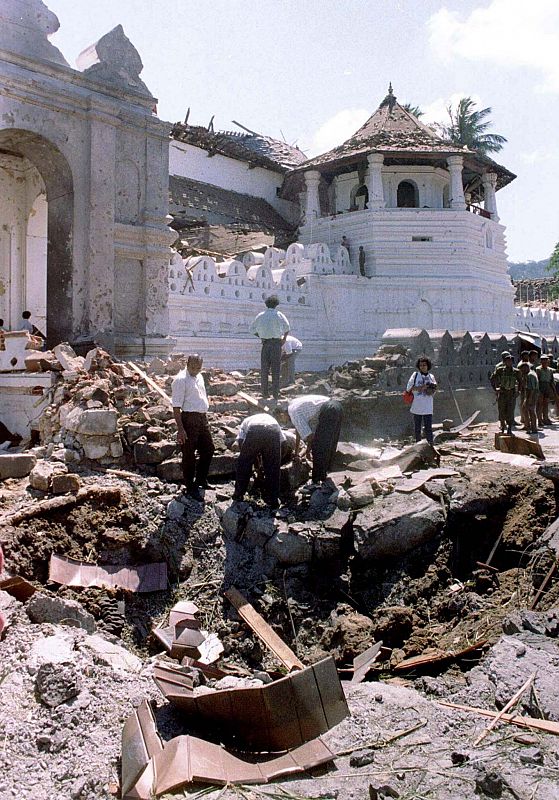 POLICE EXAMINE THE SITE OF A BOMB ATTACK OUTSIDE A BUDDHIST TEMPLE