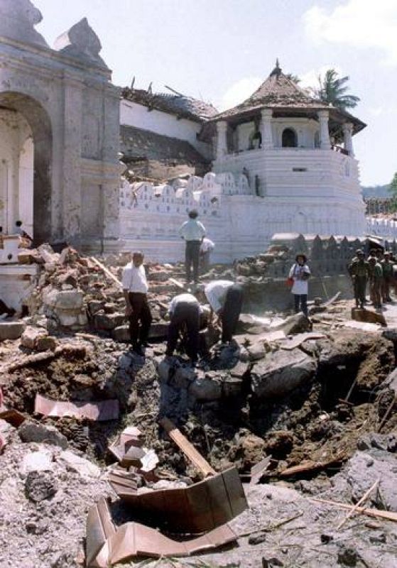 POLICE EXAMINE THE SITE OF A BOMB ATTACK OUTSIDE A BUDDHIST TEMPLE
