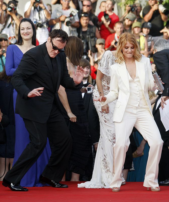 Director Tarantino dances on red carpet with cast member Laurent as they arrive for screening of film "Inglourious Basterds" at Cannes