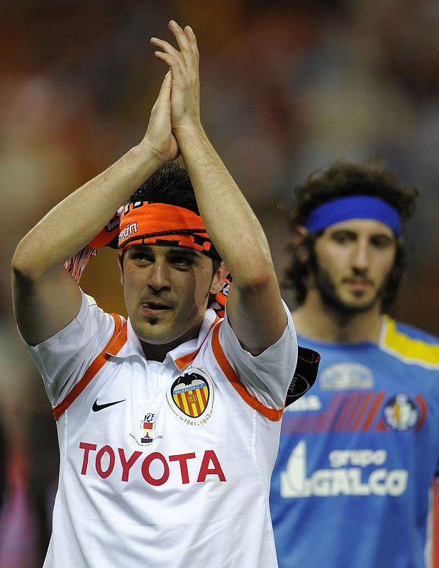 Valencia's David Villa celebrates in front of Getafe's Granero  after King's Cup final in Madrid