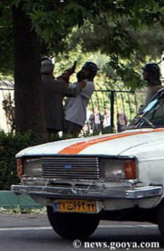 A struggle is seen during a march on a street in Tehran