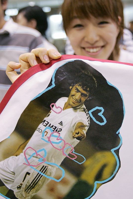 A Japanese fan holds an image of Real Madrid's Raul as she waits for his arrival at Tokyo's Narita airport.