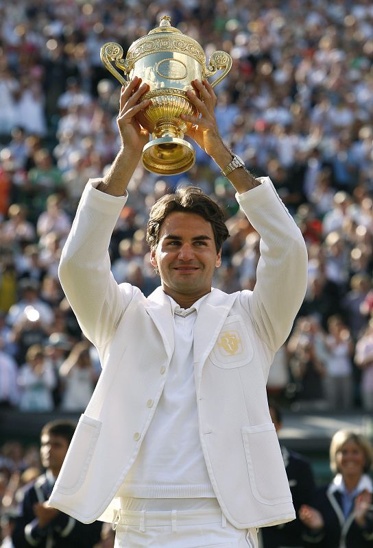 Roger Federer sujeta la copa de Wimbledon, vestido con la famosa americana con sus iniciales bordadas en el bolsillo.