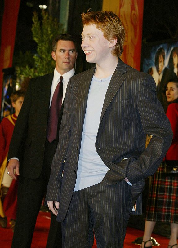 ACTOR RUPERT GRINT AT HARRY POTTER PREMIERE WITH SECURITY.