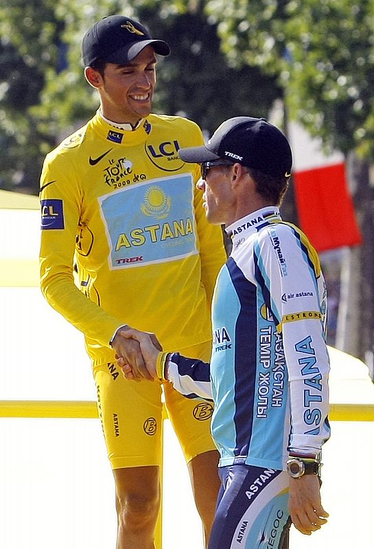 Astana rider and leader's yellow jersey Contador shakes hands with teammate Armstrong after the final stage of the Tour de France cycling race