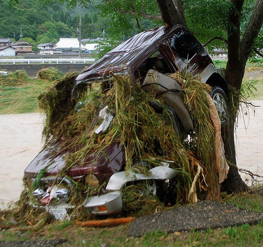 A car washed away by floodwaters is pictured in Sayo