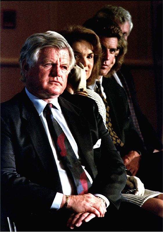 Jacqueline Kennedy Onassis (C), sitting between US Senator Ted Kennedy (L) and her son John F. Kenne..