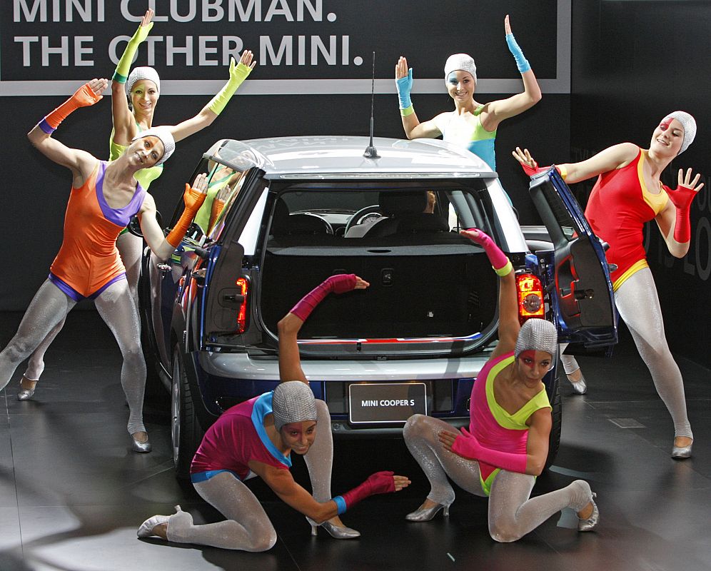 Dancers perform around a Mini Cooper S during the 40th Tokyo Motor Show in Chiba