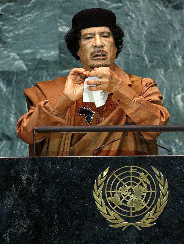 Libyan leader Gaddafi pretends to rip a charter as he addresses the 64th United Nations General Assembly at the U.N. headquarters in New York