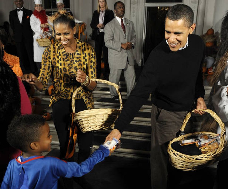 US President Obama and his wife Michelle give treats to local school children on Halloween at the White House in Washington