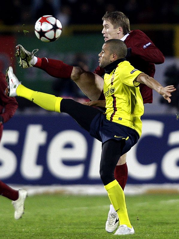 Barcelona's Alves challenges Rubin Kazan's Ryazantsev during their Champions League soccer match at the Central stadium in Kazan,