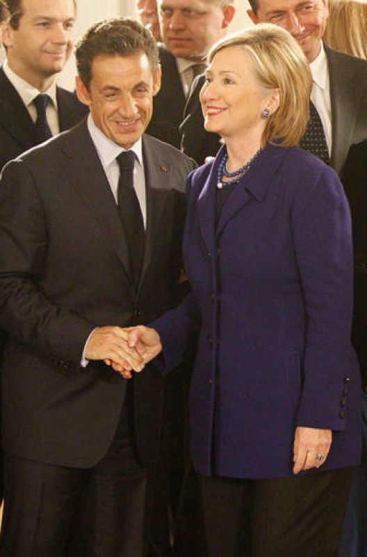 French President Sarkozy and U.S. Secretary of State Clinton shake hands during a reception at the presidential Bellevue Palace in Berlin