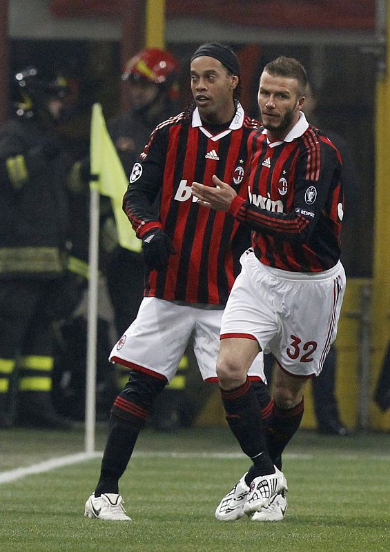 AC Milan's Beckham celebrates after teammate Ronaldinho scores against Manchester United during their Champions League soccer match in Milan