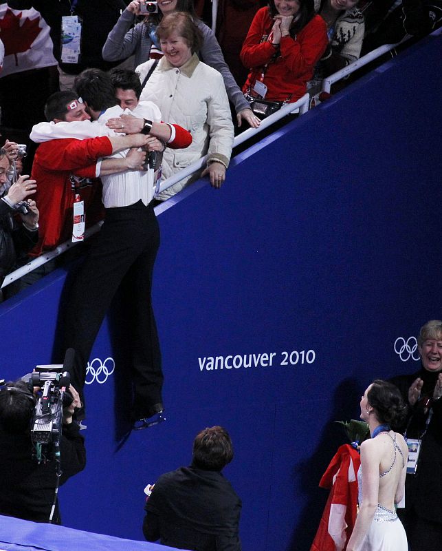 Canada's Moir is embraced by members of the crowd after winning a gold medal in the ice dance figure skating event at the Vancouver Winter Olympics