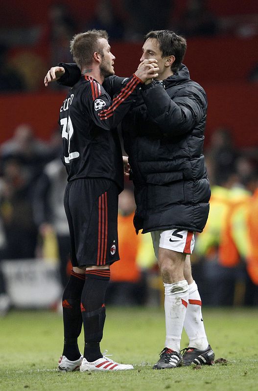 AC Milan's Beckham embraces Manchester United's Neville as he leaves the pitch following their Champions League last 16, second leg soccer match at Old Trafford in Manchester